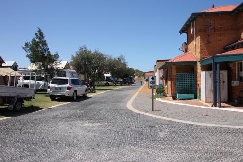 a street in a town with a car parked on the road at Seaspray Beach Holiday Park in Dongara