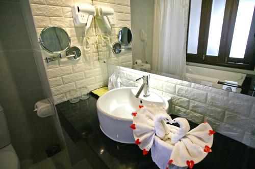 a bathroom with a sink and two towels at Park View Hotel in Hue