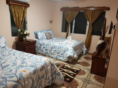 a bedroom with two beds and a dresser at Beya Suites in Punta Gorda