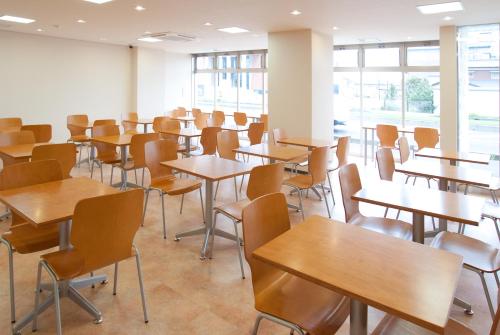 an empty classroom with tables and chairs at Hotel Aston Plaza Himeji in Himeji