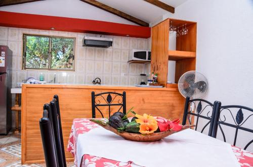 a bowl of fruit on a table in a kitchen at Cabañas MANA NUI INN in Hanga Roa