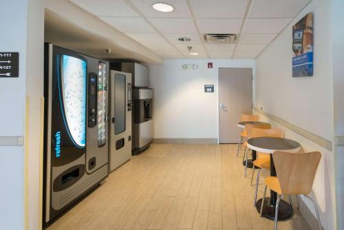 a room with a large television and a table and chairs at Motel 6-Hillsboro, TX in Hillsboro