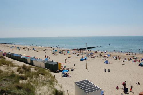 a beach with a lot of people on it at Strandcamping Valkenisse in Biggekerke