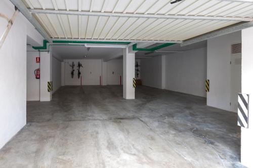 an empty garage with white walls and a ceiling at Ag Casa Del Mar Premium in Gandía