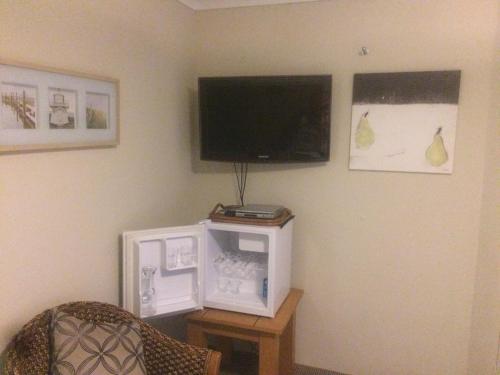 a television sitting on top of a wooden table at Breakwater Short Stay in Mandurah