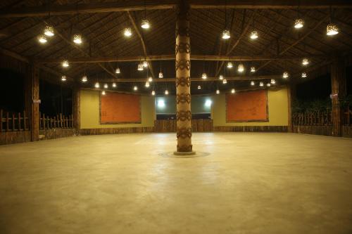a large hall with a pole in the middle at Breathing Earth - Rooms and Pool in Kolkata