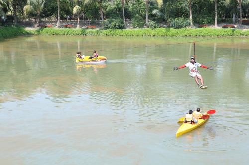 a group of people on kayaks in a lake at Breathing Earth - Rooms and Pool in Kolkata