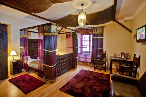 a living room with a bed and a desk at Castle Inn in Warsaw