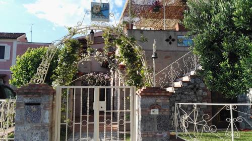 a gate in front of a building with vines at B&B La Torretta in Maratea