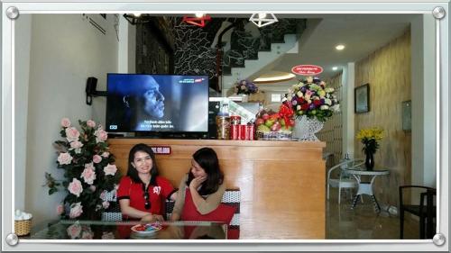 two women sitting at a counter in a store at HD House in Noi Bai