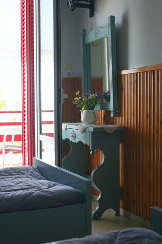 a bedroom with a bed and a mirror on a table at Diamanto Rooms in Eretria