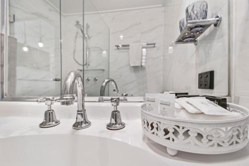 a bathroom with a sink and two faucets at Alzburg Resort in Mansfield