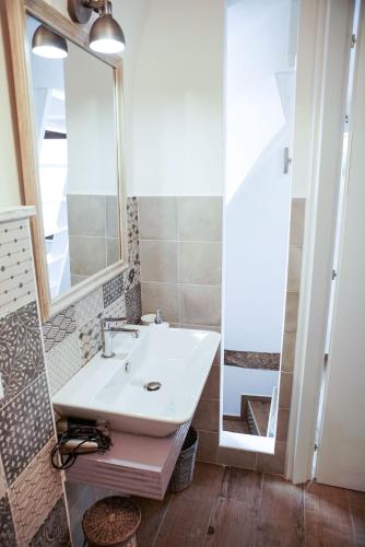 a bathroom with a sink and a mirror at Dimora Maestà in Putignano