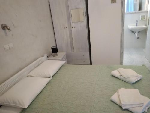 a white room with two beds and a sink at Anastasia in Aliko Beach