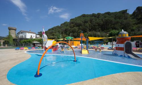a swimming pool with a bunch of people in it at Medplaya Aparthotel Sant Eloi in Tossa de Mar