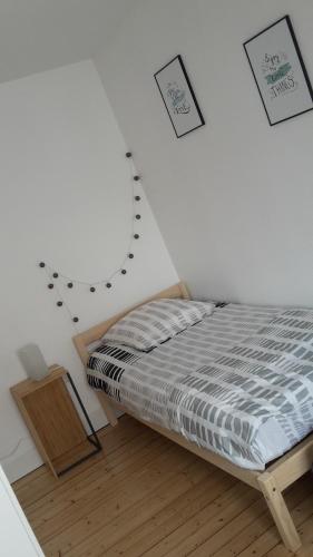 a bedroom with a bed and a wall with drawings at Le Vicus in Eckbolsheim