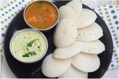 a plate of food with dip and pita crisps at Indian Art Villa in Varkala