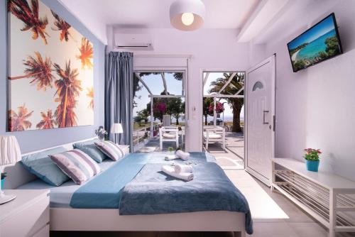 a bedroom with a large bed and a balcony at Acapus Studios in Toroni