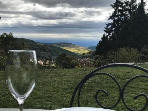 a wine glass sitting on top of a table at Le Holzberg et ses Suites in Osenbach