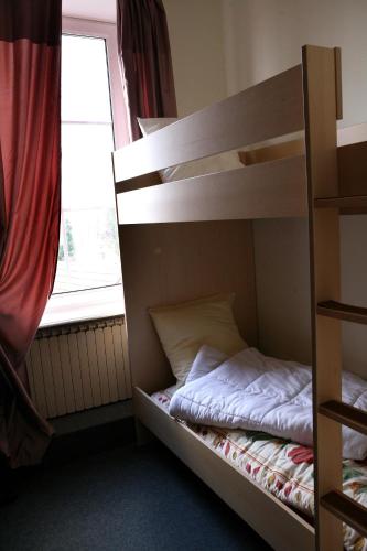 a bedroom with two bunk beds and a window at La Maison ERNENWEIN in Obermodern