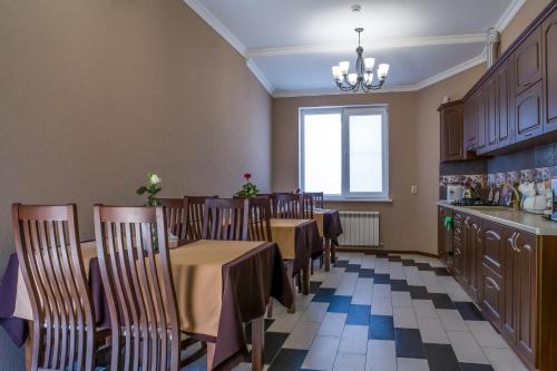 a dining room with tables and chairs and a window at Hotel Kristall in Kislovodsk