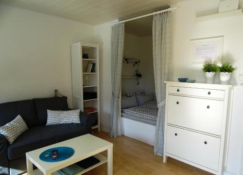 a living room with a couch and a closet at Ferienwohnung Robbe in Bremerhaven