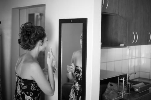 a woman standing in front of a mirror at Rusticana Hospitality Estate in Klapmuts