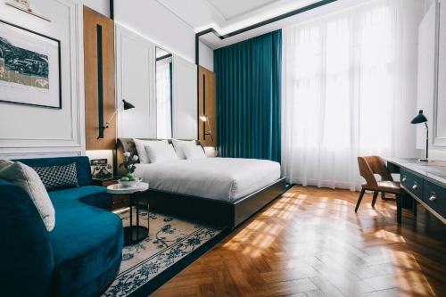 a hotel room with a bed and a couch at Yangon Excelsior in Yangon