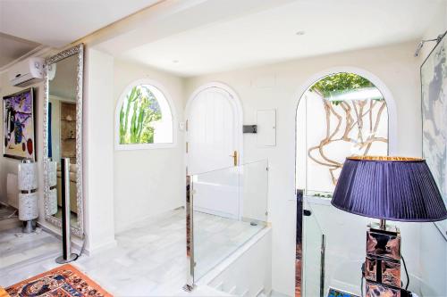 a dressing room with a mirror and a lamp at Luxury Villa with swimming pool and Jacuzzi in Marbella