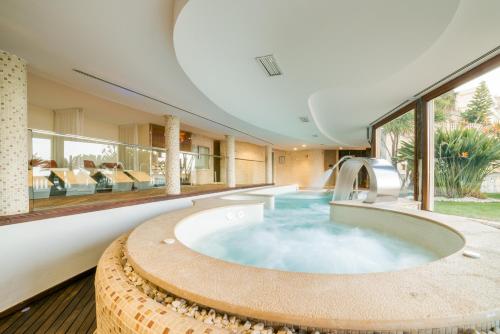 a pool in the middle of a house at Nixe Palace in Palma de Mallorca