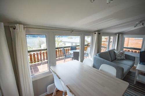 a living room with a table and a couch at Grande Hytteutleige og Camping in Geiranger