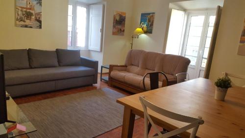 a living room with a couch and a table at HENRI'S APARTMENTS - City Centre in Lagos