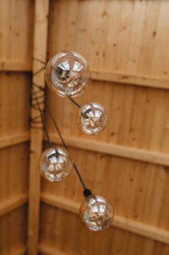 a group of lights hanging from a wall at Planinska Koliba Exclusive in Sekulić 