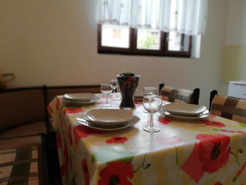 una mesa con platos y copas de vino. en Apartment Marina, en Malinska