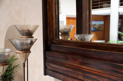 a mirror with some bowls in front of a window at Hotel Santa Isabel in Toledo