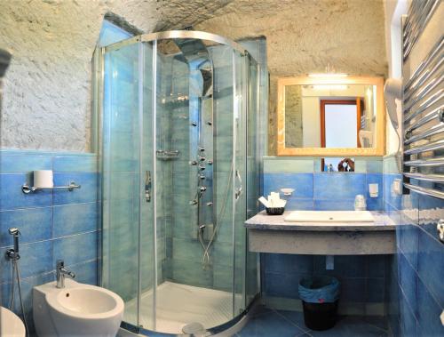 a bathroom with a glass shower and a sink at Hotel Villa Cimmentorosso in Ischia