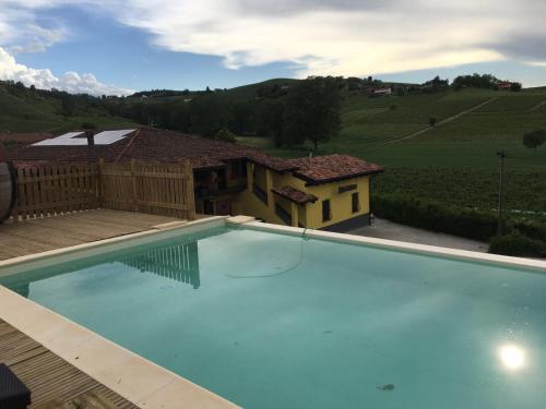 a large swimming pool in front of a house at C' Era Una Volta in Canelli