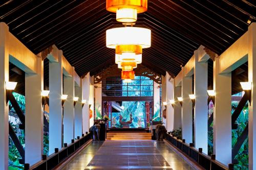 a hallway of a building with lights on the ceiling at Dusit Thani Laguna Phuket in Bang Tao Beach