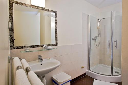 a bathroom with a sink and a shower at Castle Inn in Warsaw