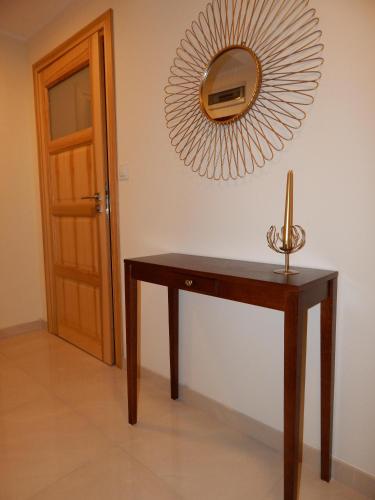 a wooden table with a mirror on the wall at Apartamenty "Kotlina" in Bystrzyca Kłodzka