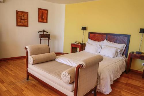 a bedroom with a bed and a chair in it at Boa Vista Hotel & Spa - Adults Only in Albufeira