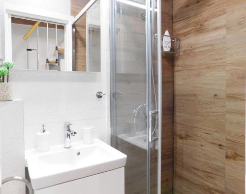 a bathroom with a white sink and a shower at Studio apartment Milla in Split