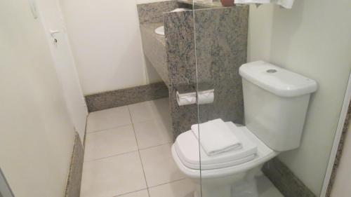 a bathroom with a toilet and a sink at Atlântico Centro Apartments in Rio de Janeiro