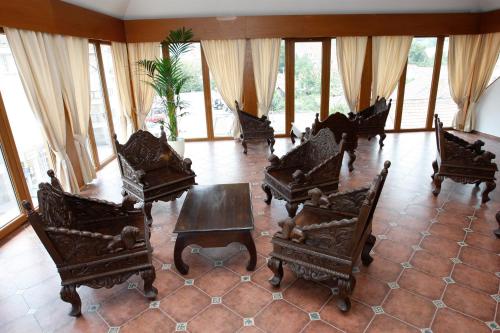 a room with chairs and a table and windows at Hotel Majolika in Modra
