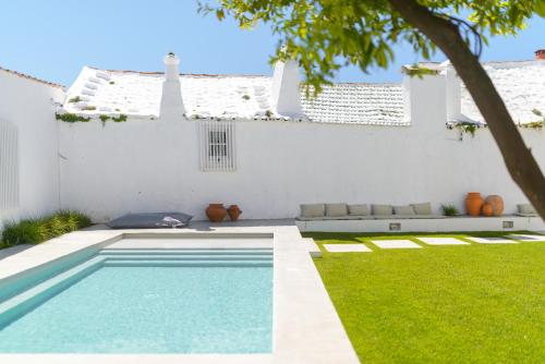 a swimming pool in the yard of a house at Dona Graca Lisbon Apartments in Lisbon