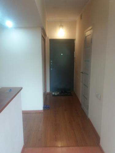 an empty room with a hallway with a door at Квартира in Almaty