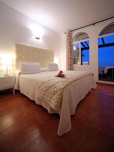a bedroom with a large bed with flowers on it at Hotel Casa Rosa in Benalmádena