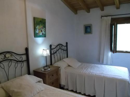 a bedroom with two beds and a window at Apartamento San Mamés in San Mamés