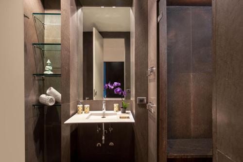 a bathroom with a sink and a mirror at MyTALE Apartment Luxury Torre Argentina in Rome