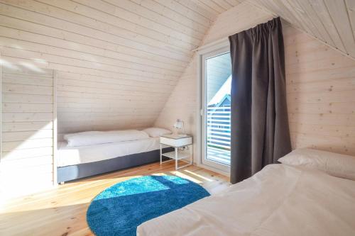 a small room with two beds and a window at Xanadu Resort in Sianozety